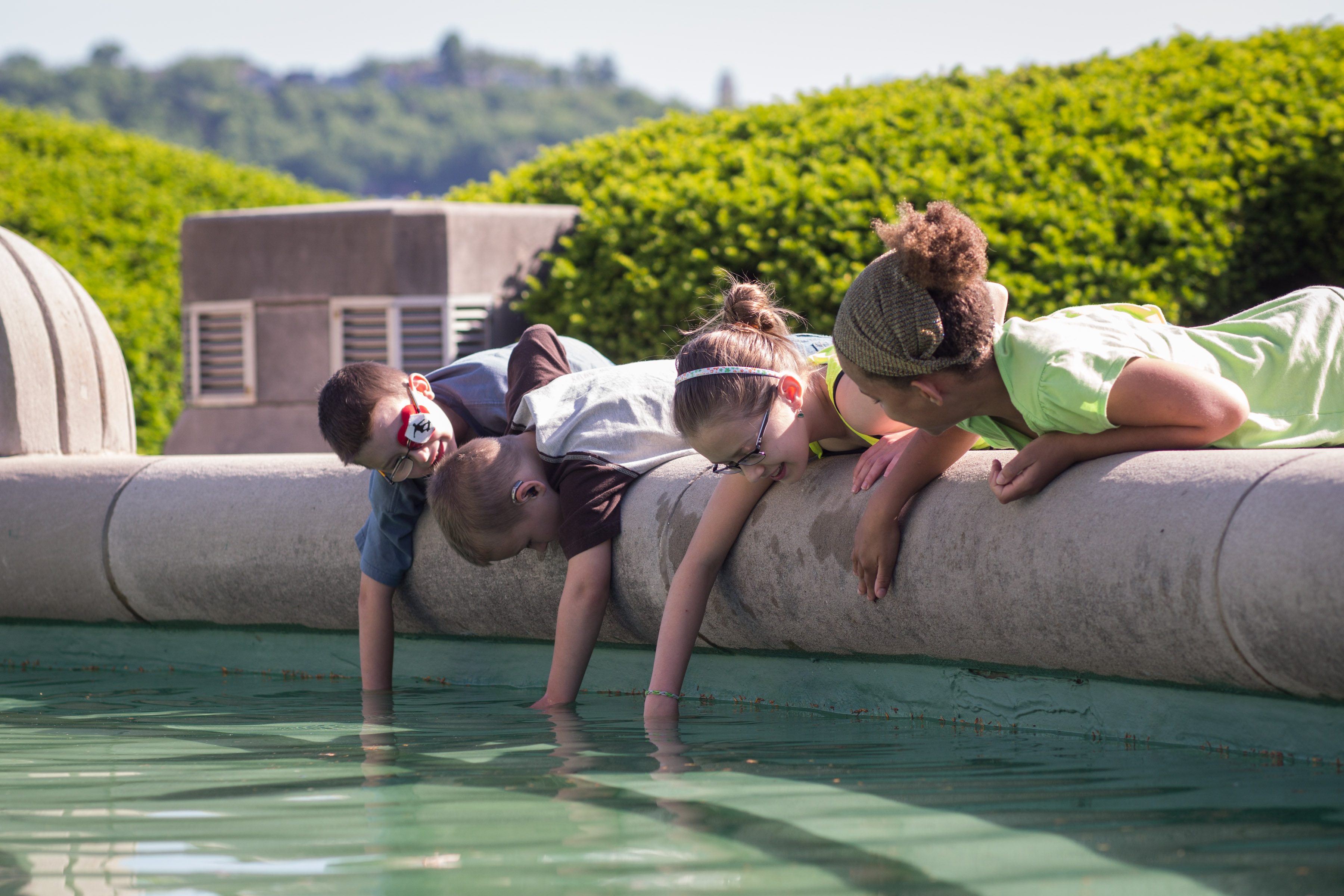 children interacting with the Union Terminal fountain in the summer